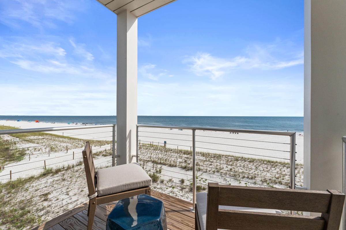 Enjoy your morning coffee with stunning ocean views from this private balcony, where soft breezes and the sound of waves create your perfect beachfront retreat.