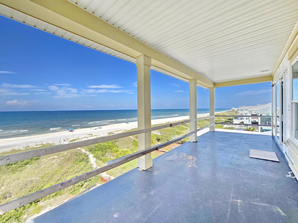 Breathe in the ocean air from your private covered balcony, where endless blue waters and soft sand stretch before you. Listen to the waves while you unwind in this peaceful beachside retreat.