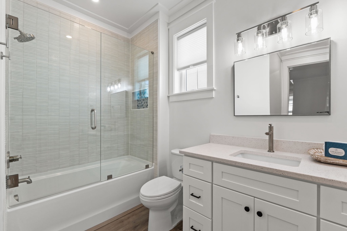 Step into your beautifully appointed bathroom featuring a luxurious soaking tub, spacious glass-enclosed shower, and elegant vanity perfect for your morning routine.