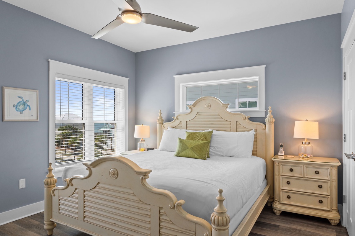 Drift into dreams in your serene bedroom, where soothing blue walls and crisp white linens create the perfect coastal retreat.
