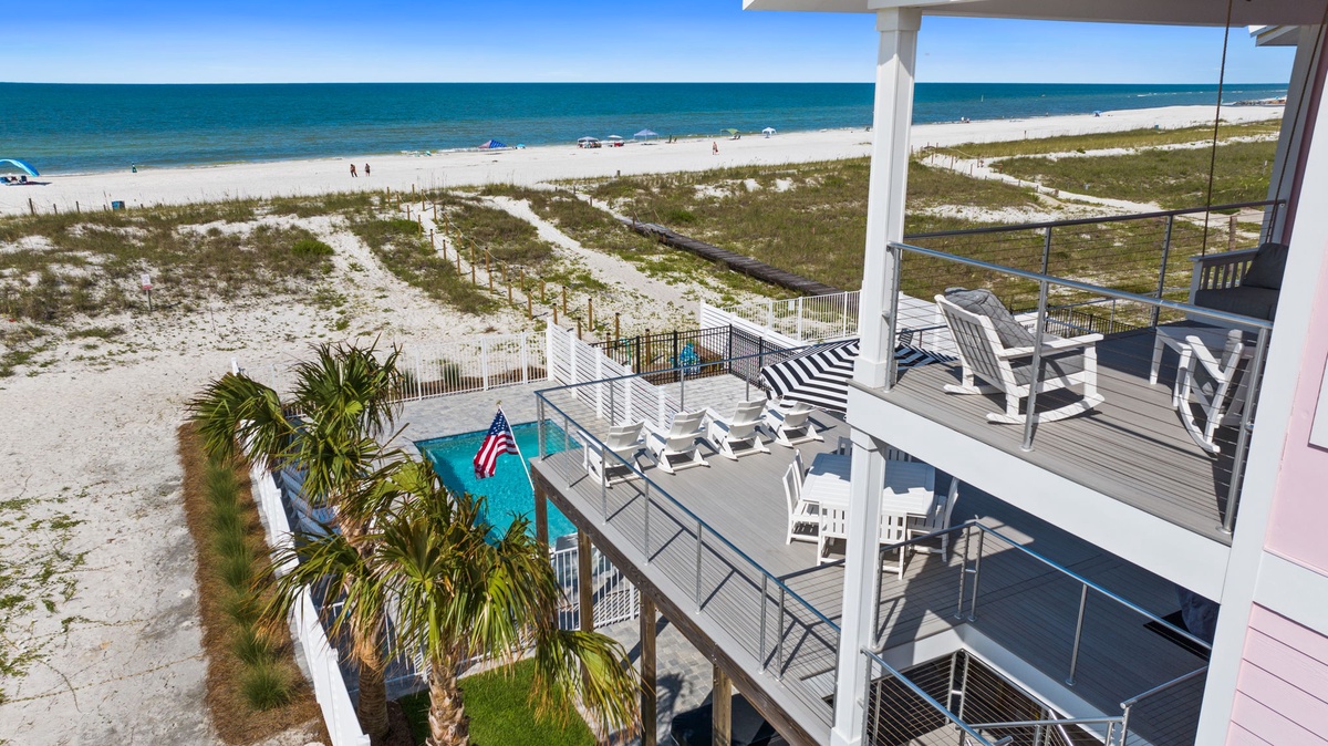 Beachfront property featuring multilevel decks overlooking white sand beaches and turquoise waters of the Gulf Coast. Ideal location for seaside getaways with direct beach access and coastal views.