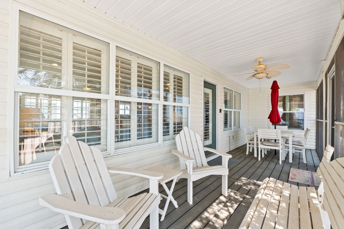 Unwind on your private screened porch where comfortable Adirondack chairs and dining space create the perfect retreat for morning coffee or evening relaxation.