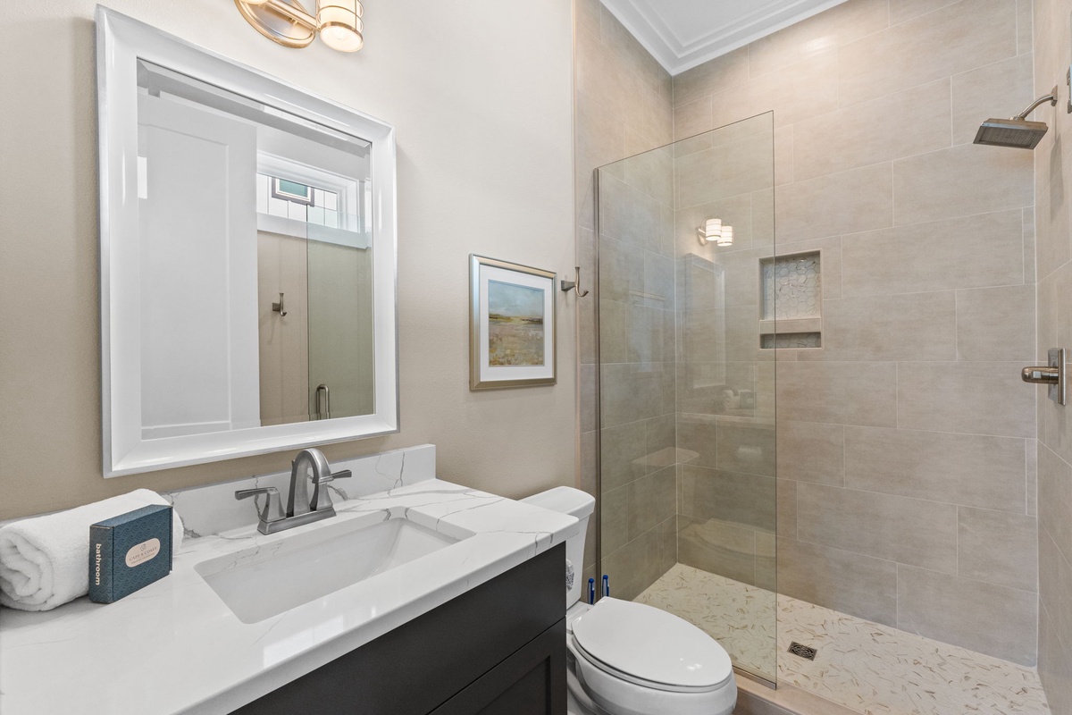Refresh in your elegant bathroom featuring a spacious walk-in shower with premium fixtures and sophisticated neutral tones.