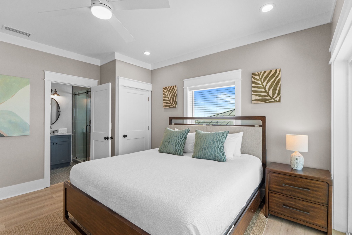 Sink into crisp linens and plush pillows in your tranquil bedroom retreat, complete with coastal-inspired décor and an ensuite bathroom for ultimate convenience.