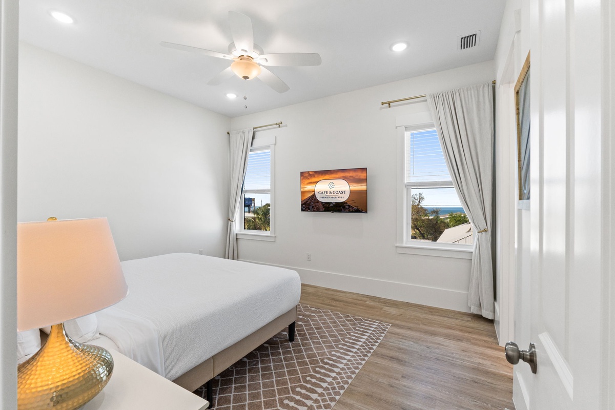 Wake up to ocean views from your bright bedroom with ceiling fan comfort and natural light streaming through dual windows.