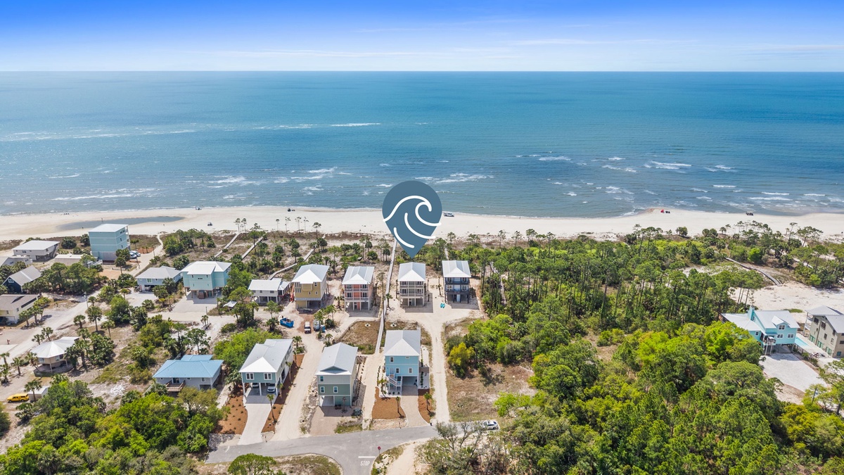 Stunning beachfront location with pristine white sand and crystal-clear waters just steps from modern vacation homes.