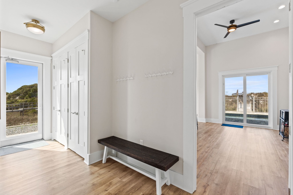 Your bright entryway welcomes you with pool views and thoughtful storage, while natural light floods the open living spaces beyond.