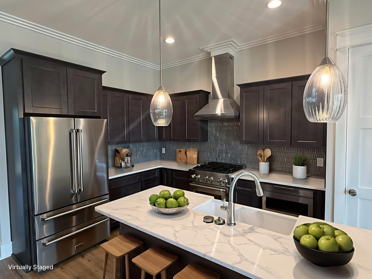 Your gourmet kitchen awaits with marble counters, stainless appliances, and elegant pendant lighting for memorable meal preparation.