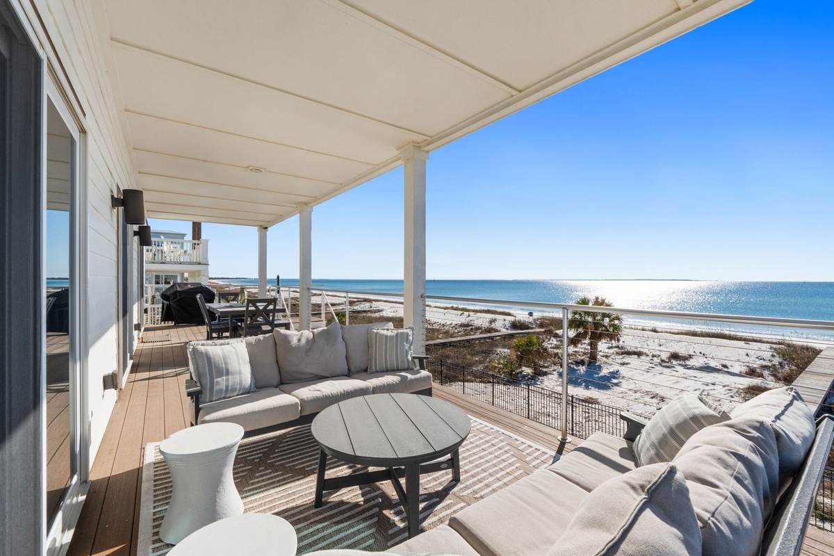 Relax on your private covered terrace with plush seating while watching waves dance across pristine white sand.