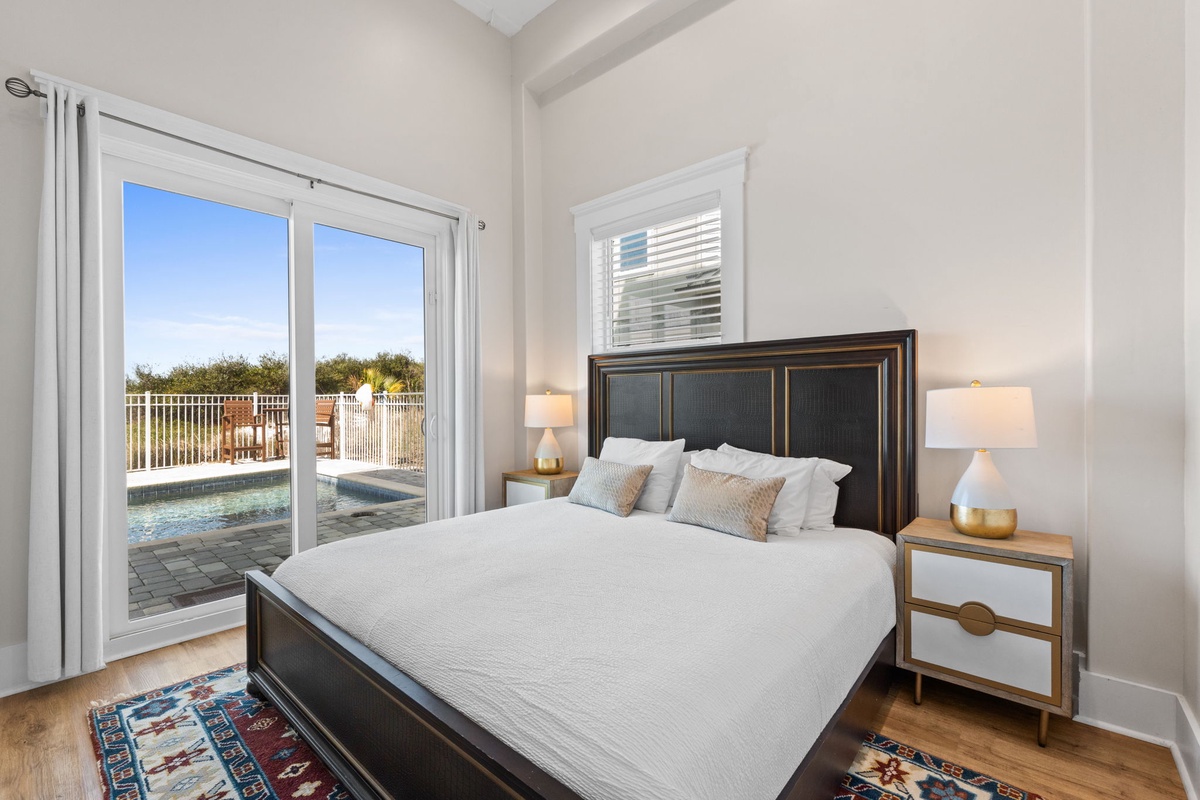 Wake up to serene pool views from your elegant master bedroom, where soft linens and peaceful mornings create the perfect start to your day.