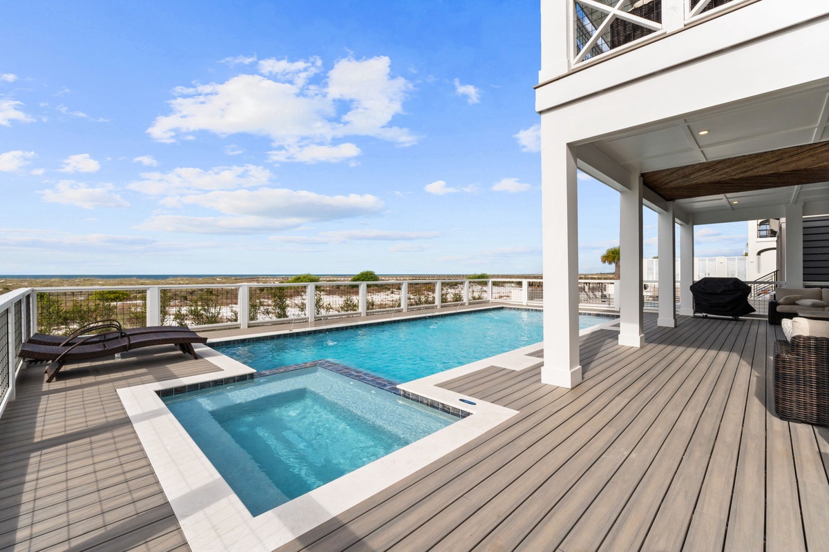 Modern oceanfront escape with private pool and hot tub on expansive deck overlooking pristine coastline.