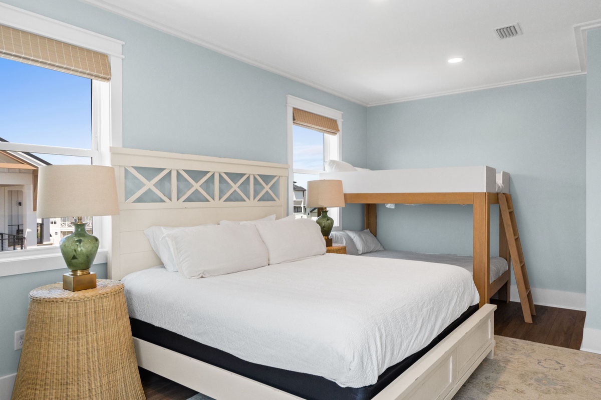 Your coastal bedroom offers crisp linens and soothing ocean-inspired tones. Wake to natural light streaming through woven shades, perfect for families with flexible sleeping arrangements.