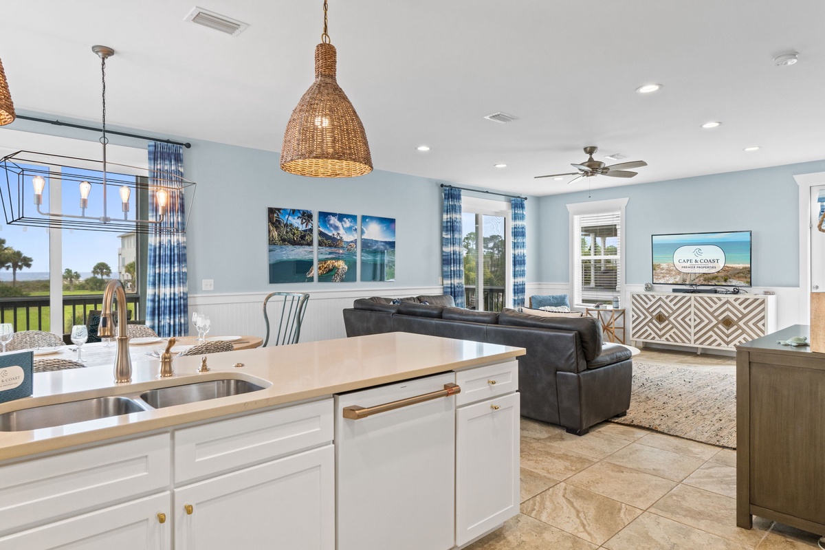 Relax in this bright, open-concept space where your kitchen flows into a stylish living area. Enjoy serene views through floor-to-ceiling windows and unwind on cozy seating after a day of adventure.