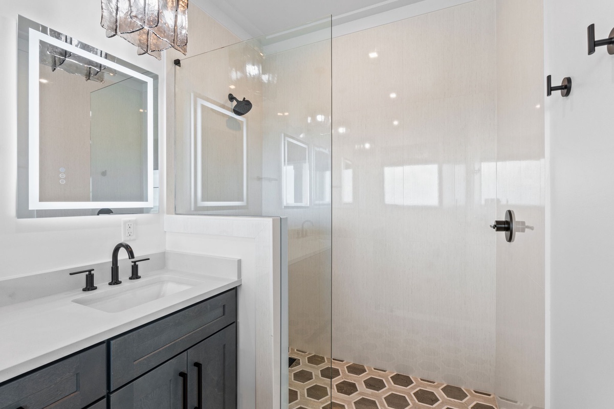 Unwind in your spa-like bathroom with a walk-in shower, LED-lit mirrors, and elegant tile work designed for your ultimate comfort.