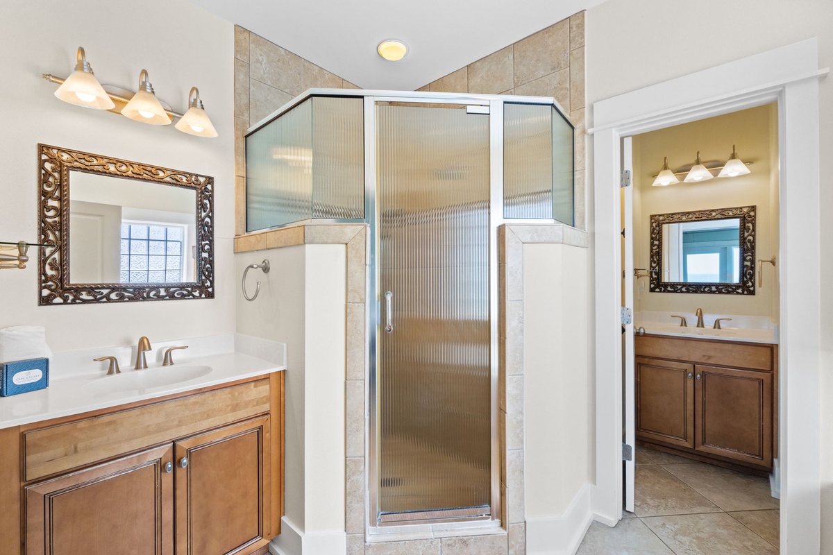 Unwind in your luxurious master bathroom with elegant dual vanities and a spacious glass-enclosed shower.