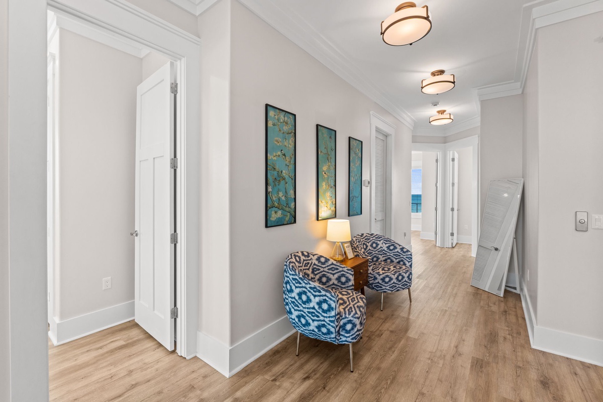 Step into your elegant hallway where artistic touches and cozy seating create a welcoming first impression of your refined coastal retreat.