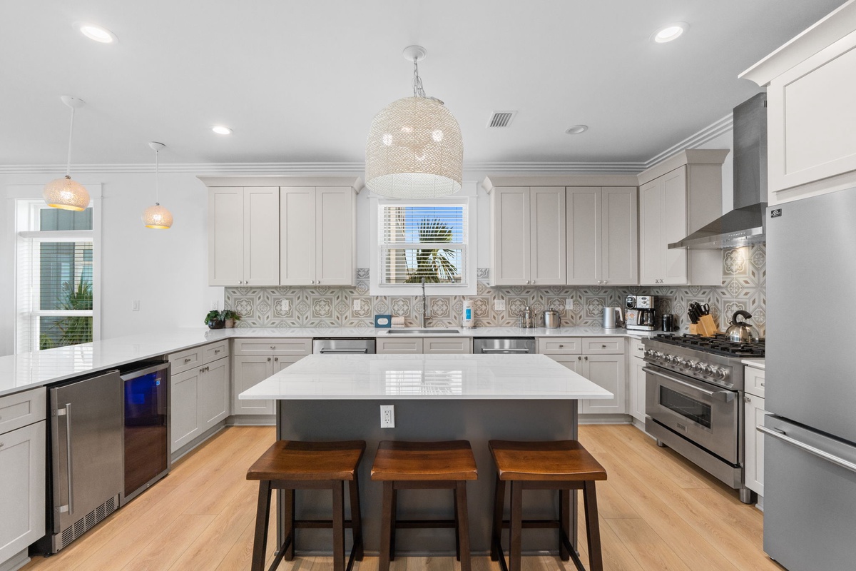 Your gourmet kitchen awaits—gleaming countertops, professional-grade appliances, and an inviting island where you can gather for morning coffee or prepare memorable meals together during your stay.