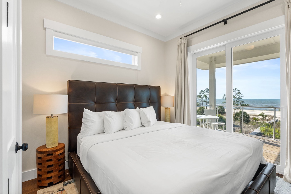 Wake up to breathtaking ocean views from your comfortable bed, where crisp linens meet coastal serenity through expansive windows.