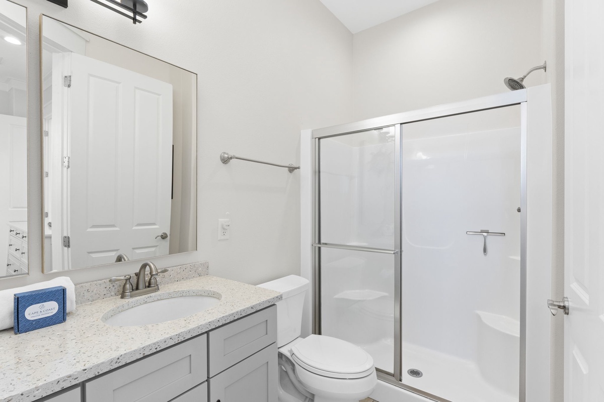 Your private bathroom features modern fixtures, spacious glass-enclosed shower, and granite countertops for comfortable daily routines.