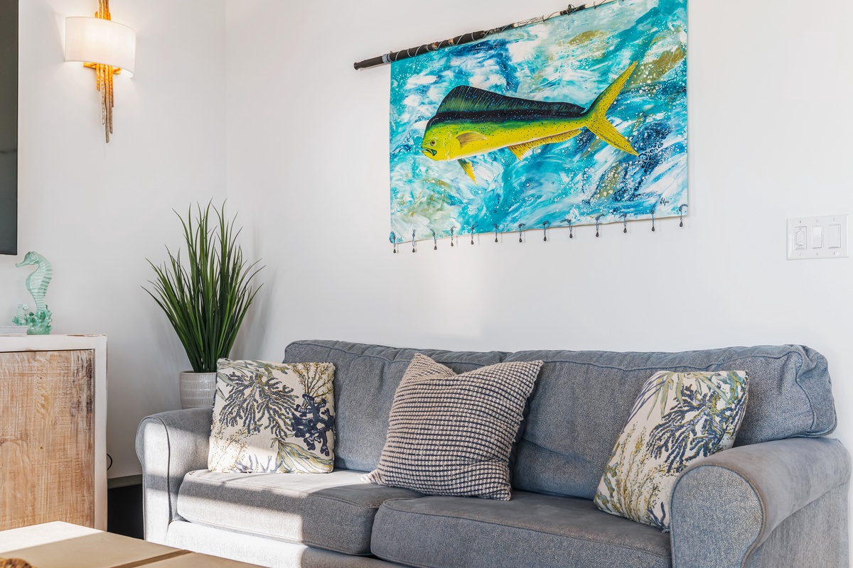 Relax on your comfortable sofa while enjoying vibrant coastal artwork and coastal-themed decor that brings ocean vibes indoors.