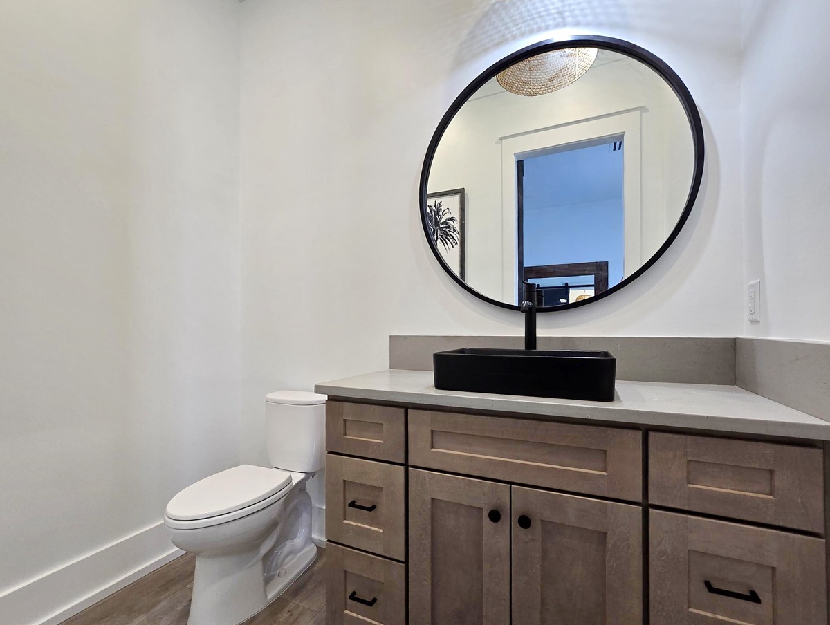 Your private bathroom features modern fixtures with elegant vessel sink and stylish round mirror for comfortable daily routines.