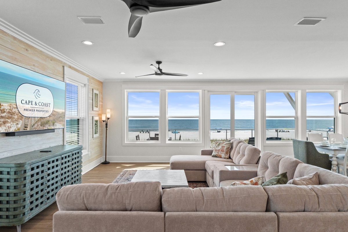 Sink into plush coastal comfort as ocean waves dance beyond your panoramic windows, where bright natural light and soothing sea breezes create your perfect beachfront retreat.