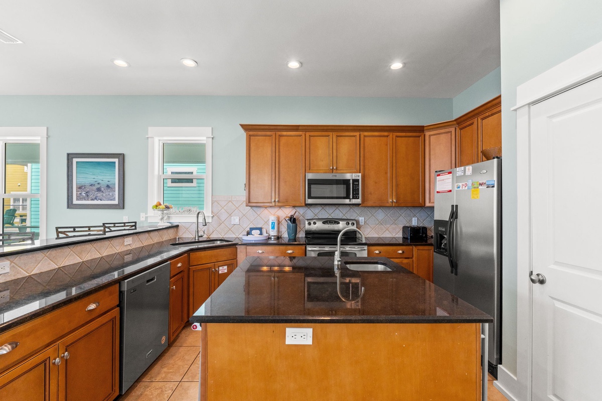 Your spacious kitchen awaits with granite counters, stainless appliances, and ocean views to inspire your culinary adventures.