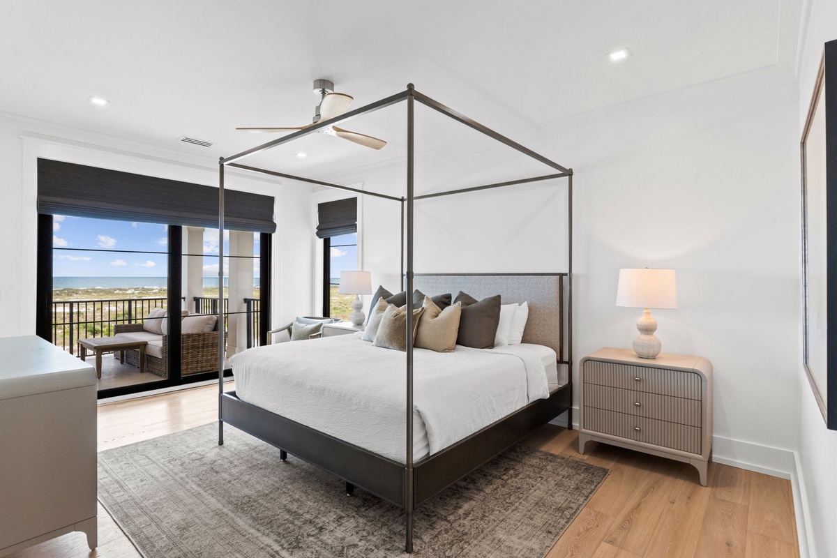 Step into your serene bedroom sanctuary with a modern canopy bed, coastal views from your private balcony, and soft lighting that creates the perfect retreat after a day of adventure.