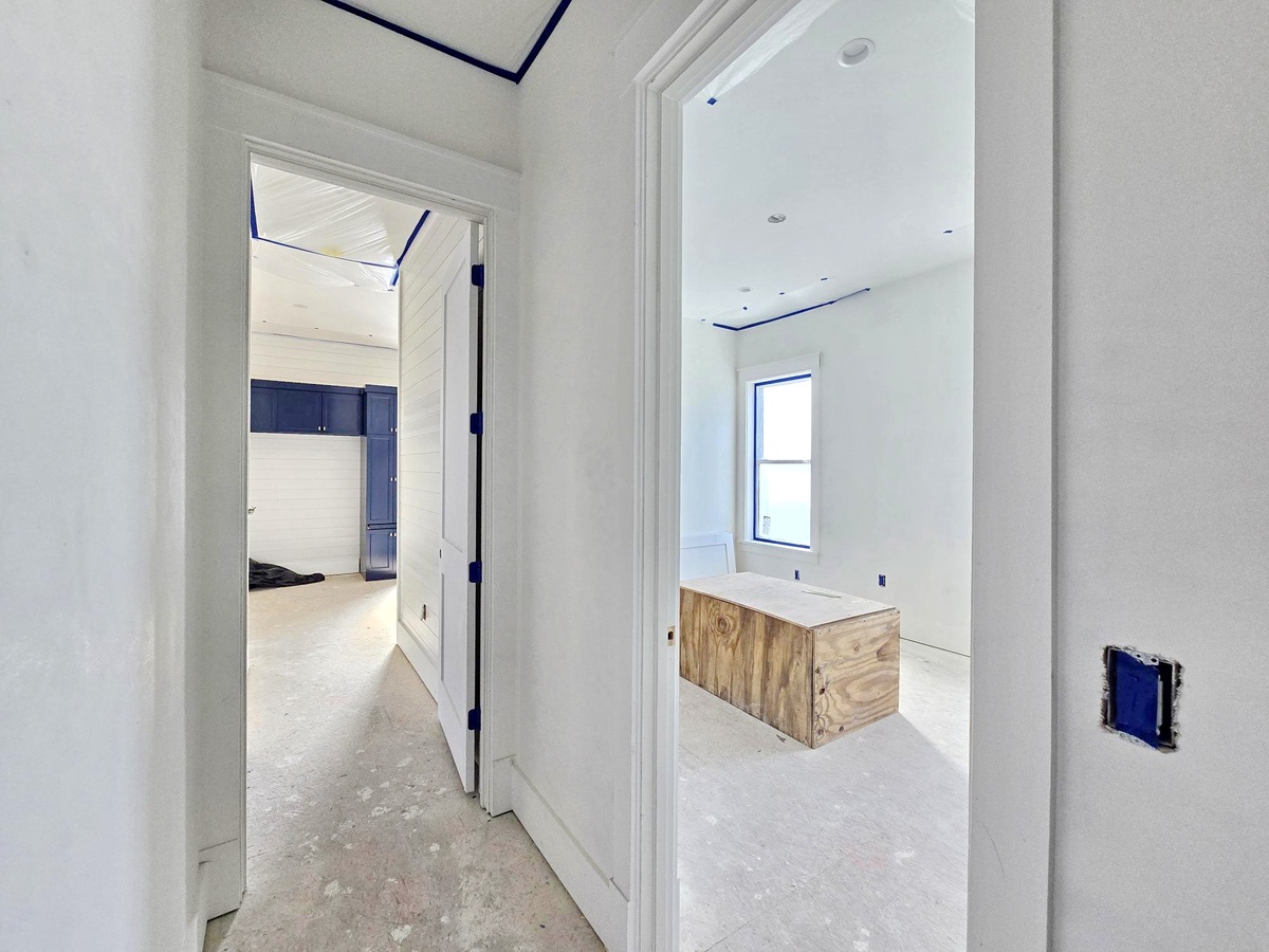 This bright hallway leads you to your private ensuite, where natural light pours in and a modern vanity awaits your morning routine.