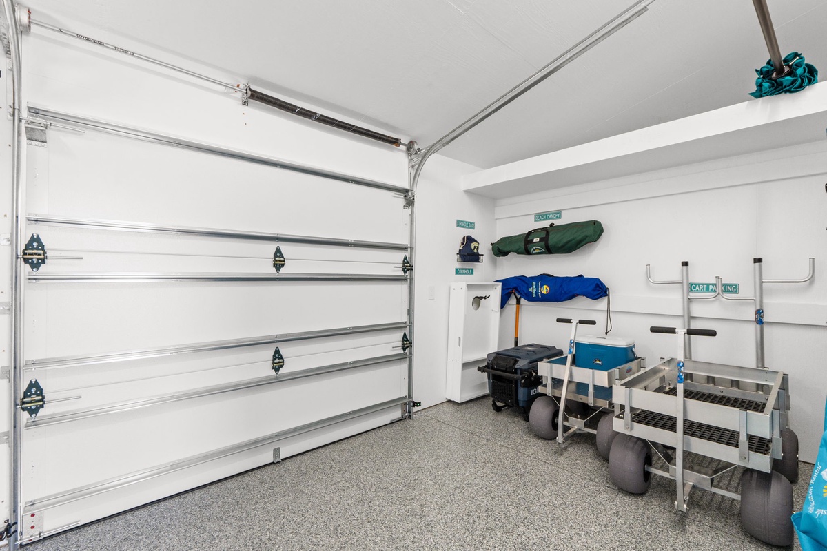 Spacious garage with organized storage racks for your beach gear, bikes, and vacation essentials—keeping everything tidy and accessible.
