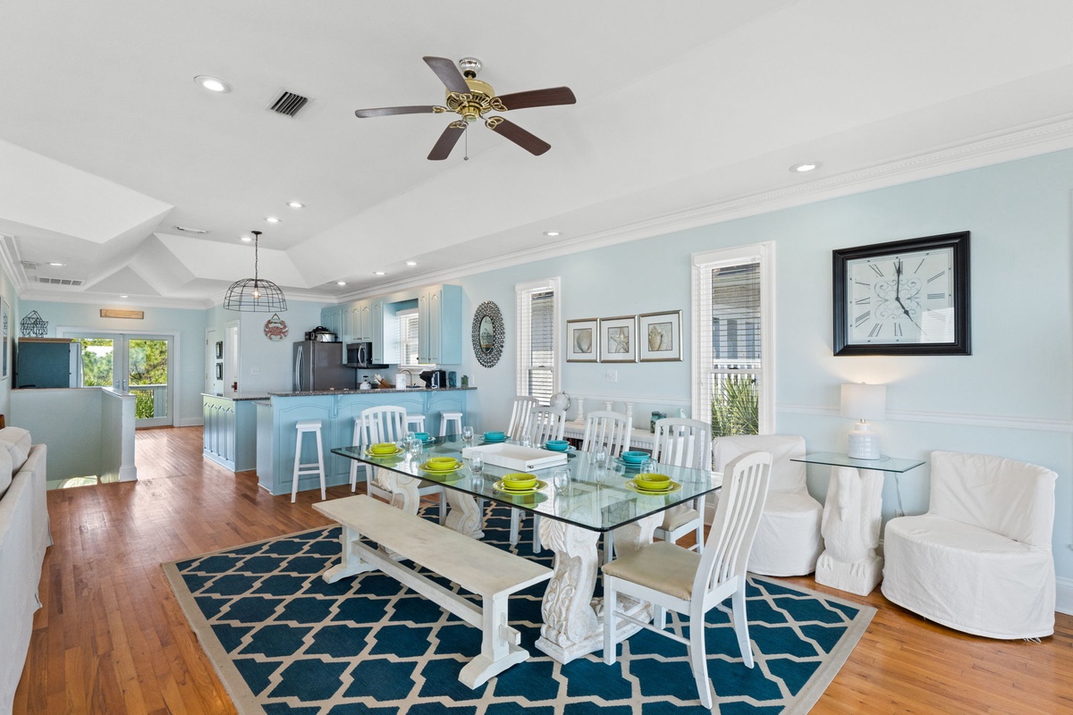 Gather around your elegant glass dining table in this airy, coastal-themed space where meals become memorable moments together.