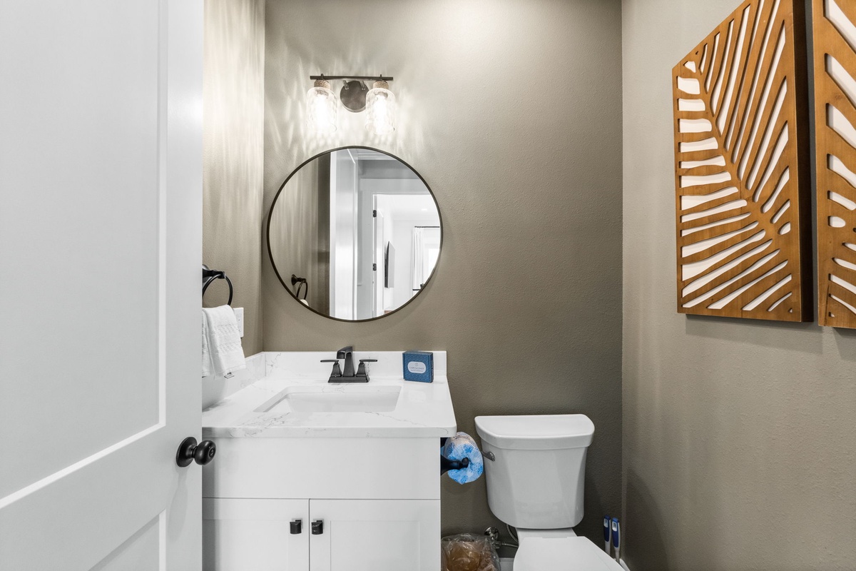 Refresh in your stylish powder room with modern fixtures, crisp white vanity, and warm wood accents creating a welcoming space.