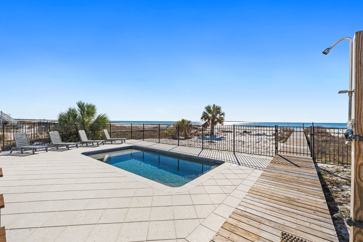 Dive into your private pool with stunning ocean views and tropical palms creating the perfect beachside retreat.