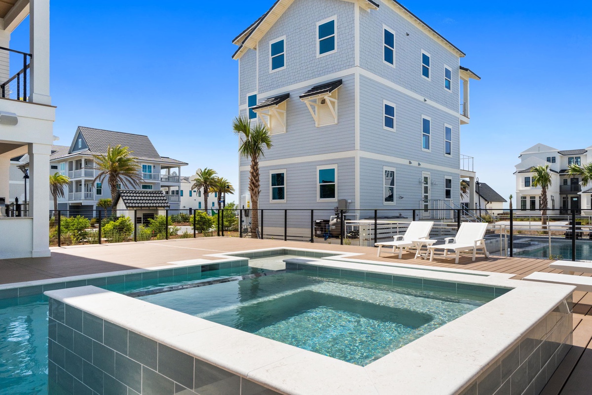 Modern beach house with private pool and hot tub in coastal community setting.
