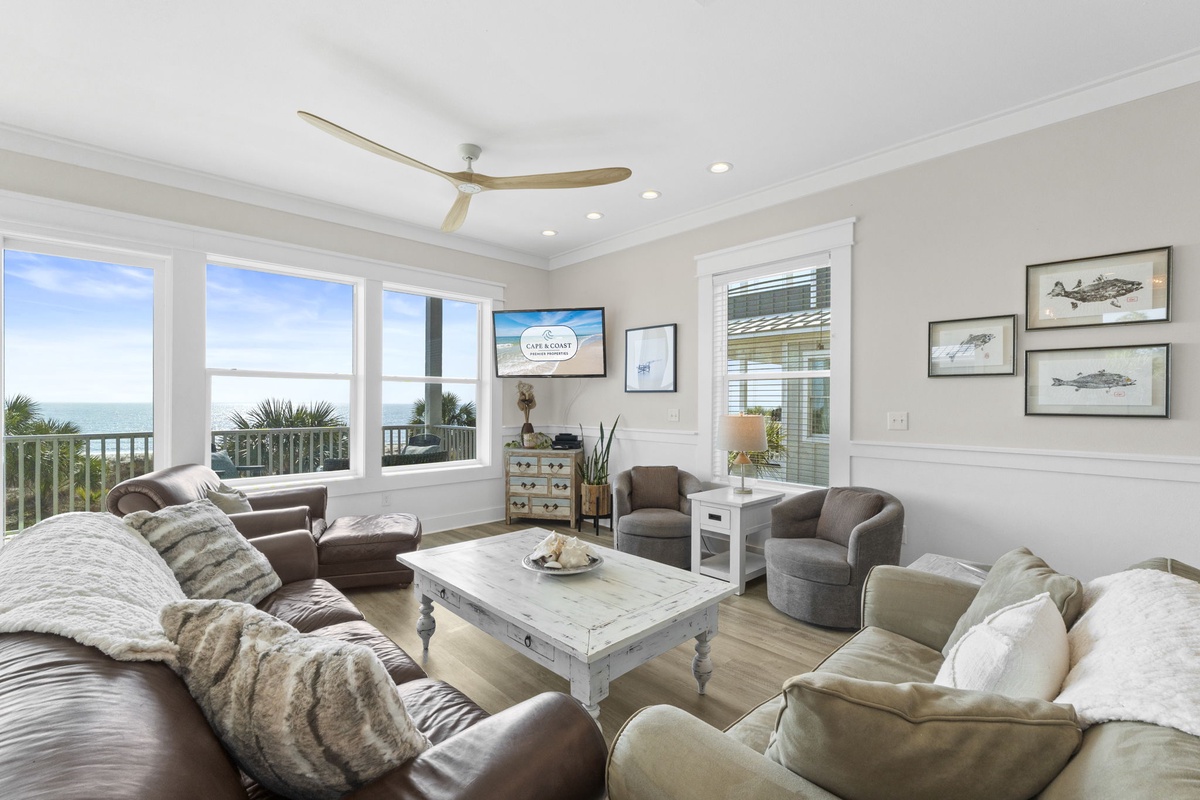 Sink into plush seating while ocean breezes flow through your coastal living room, where panoramic sea views create the perfect backdrop for relaxation.