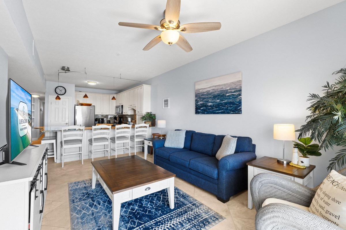 Relax in your bright, coastal-themed living space where ocean blues and crisp whites create the perfect beach getaway atmosphere.