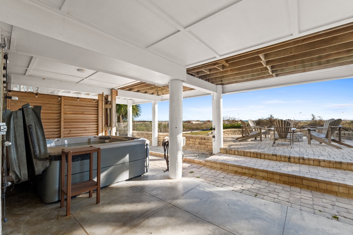 Soak in your private hot tub while enjoying ocean breezes on this expansive covered terrace with stunning coastal views.