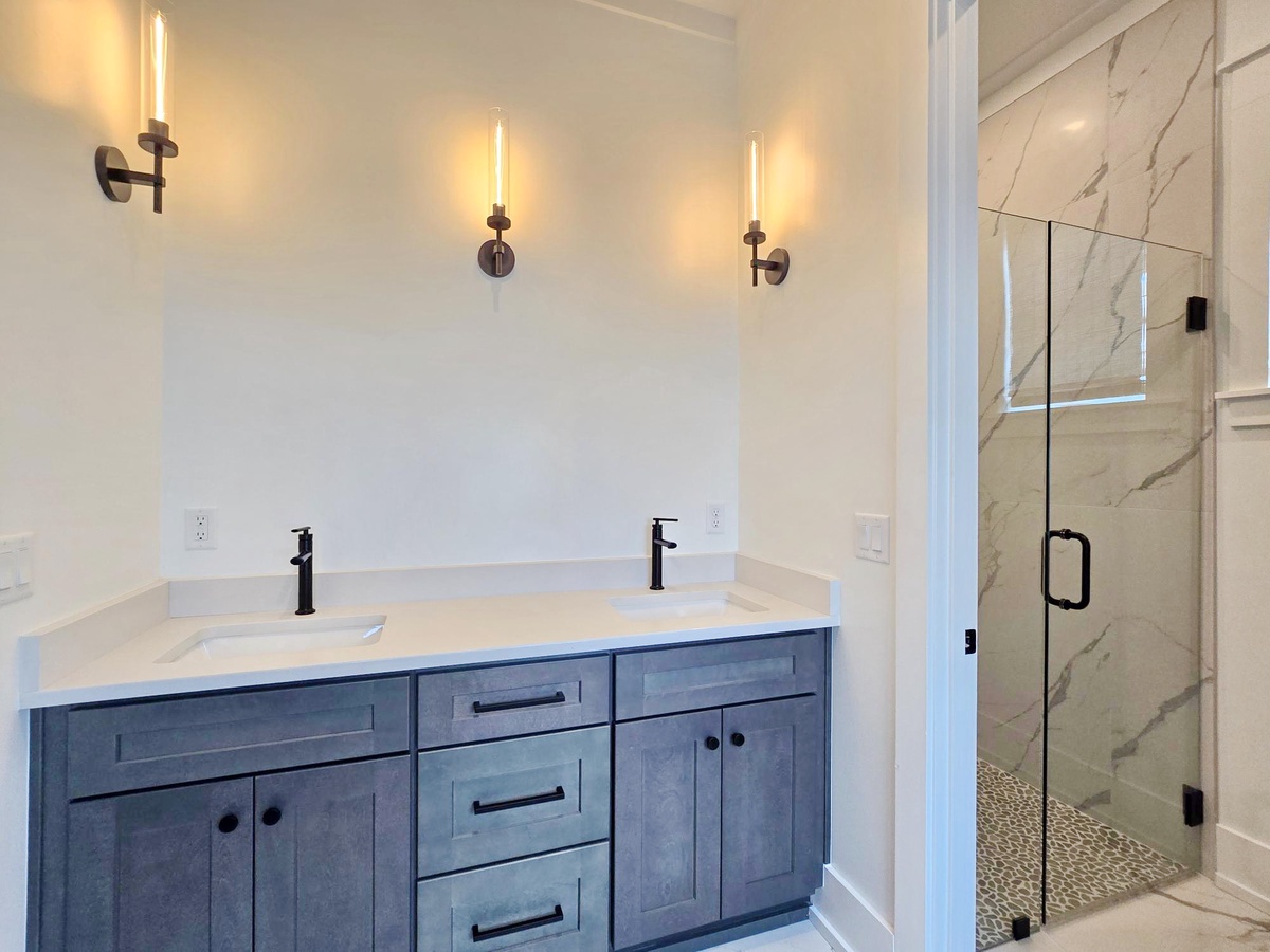 Step into your luxurious en-suite bathroom featuring elegant dual vanities and a stunning marble walk-in shower.