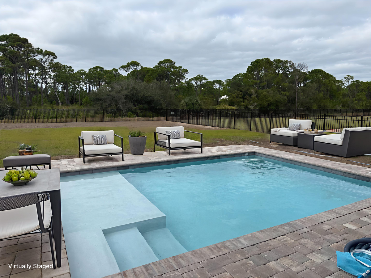 Unwind poolside with plush lounge seating and crystal-clear waters surrounded by lush natural scenery.