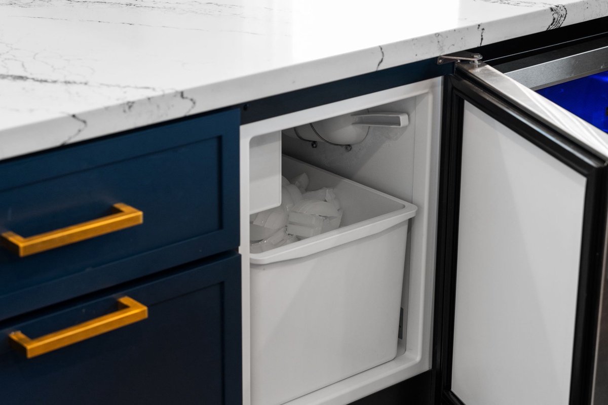 Keep your favorite drinks chilled and snacks within easy reach in this sleek kitchen minibar, perfectly tucked into the countertop for effortless entertaining.