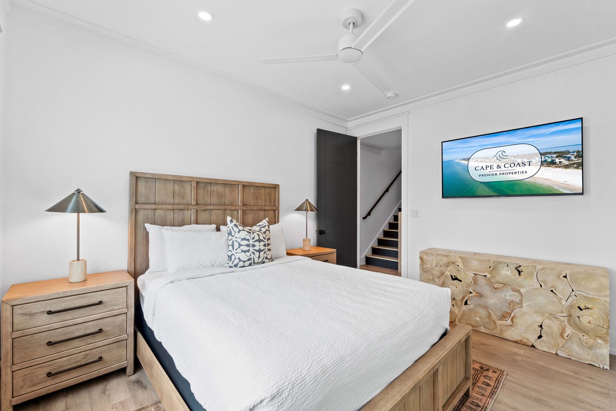 Drift into relaxation in your coastal-inspired bedroom, where crisp linens and warm wood tones set the stage for peaceful slumber after sunny beach days.