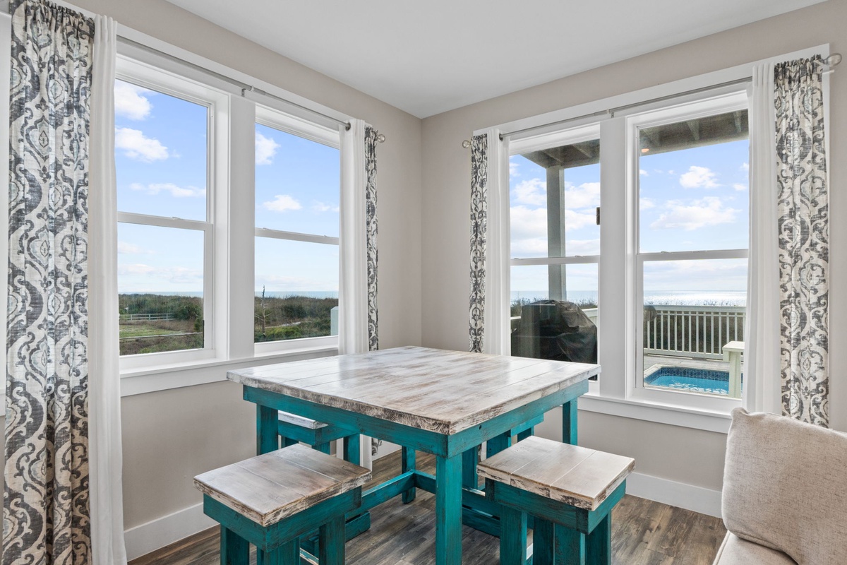 Your bright dining nook offers stunning views through large windows, perfect for morning coffee or evening meals.