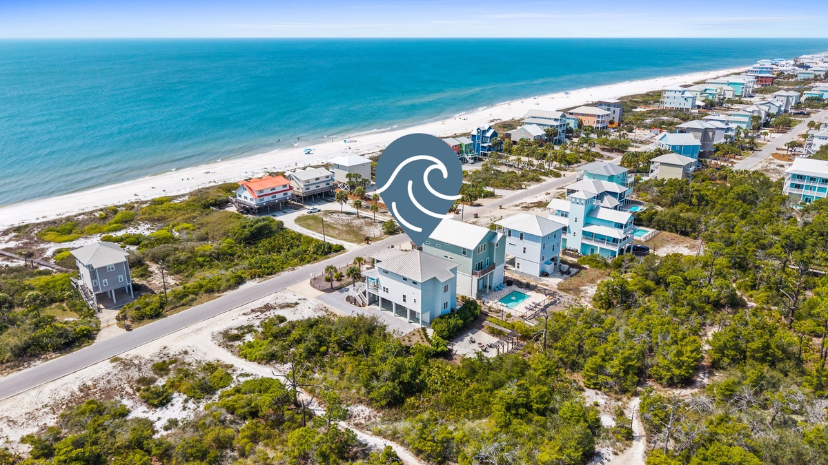 Stunning beachfront community with pristine white sand and turquoise waters stretching to the horizon.