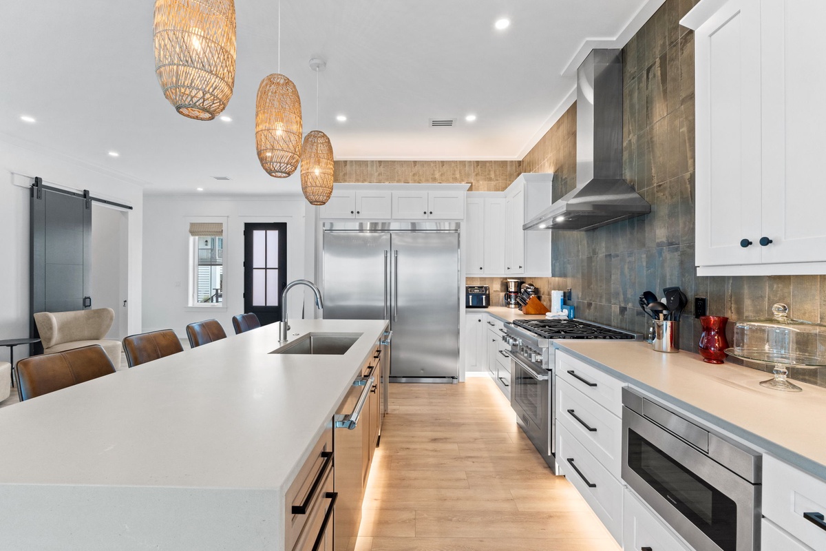 Cook with ease in your spacious chef's kitchen, featuring gleaming stainless appliances, ample counter space, and warm island seating perfect for gathering over home-cooked meals.