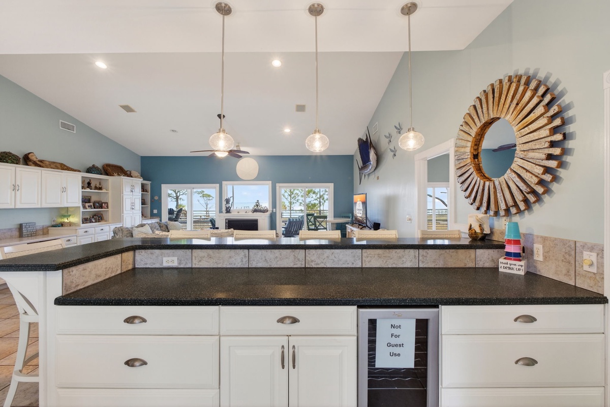 Your gourmet kitchen awaits with granite countertops, stylish pendant lighting, and stunning sunburst mirror creating the perfect space for memorable meals together.