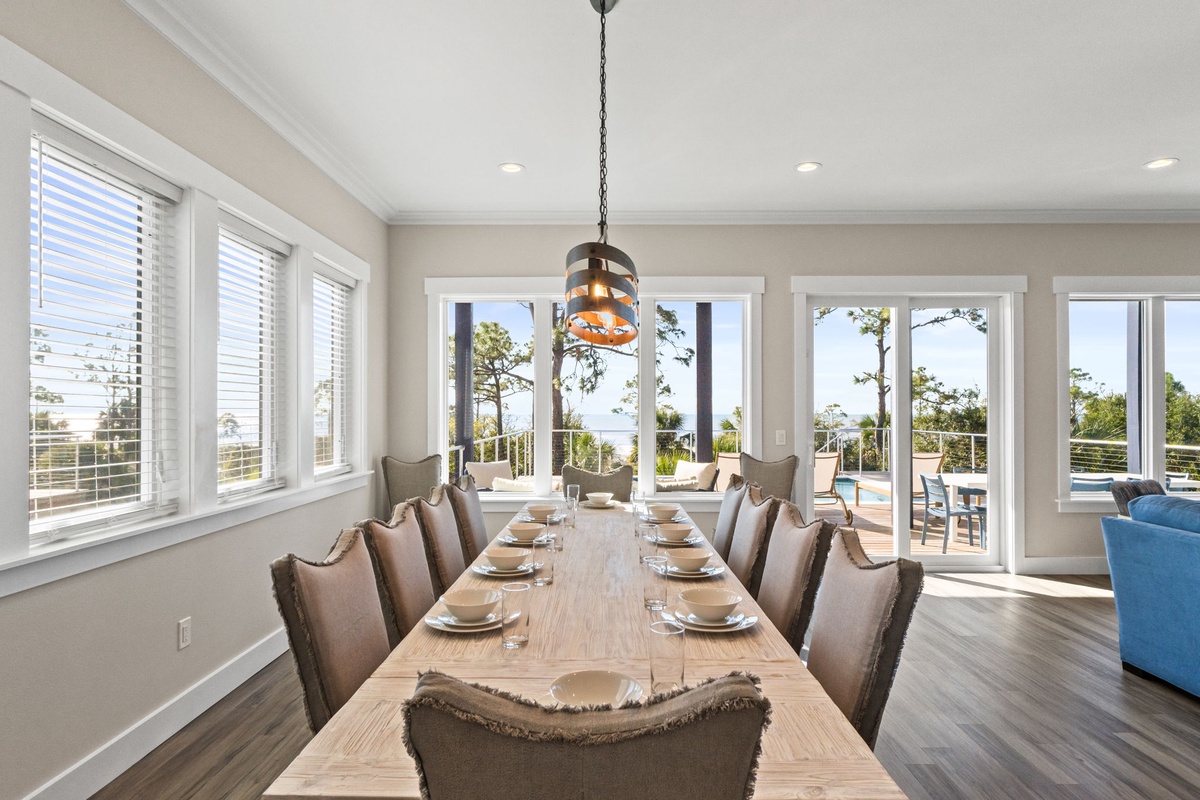 Gather around this elegant dining table for memorable meals while enjoying natural light streaming through expansive windows.