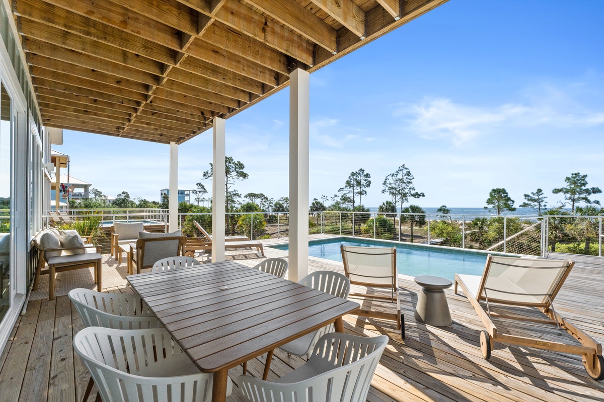 Your private covered deck offers poolside dining and lounging with stunning water views through the trees.