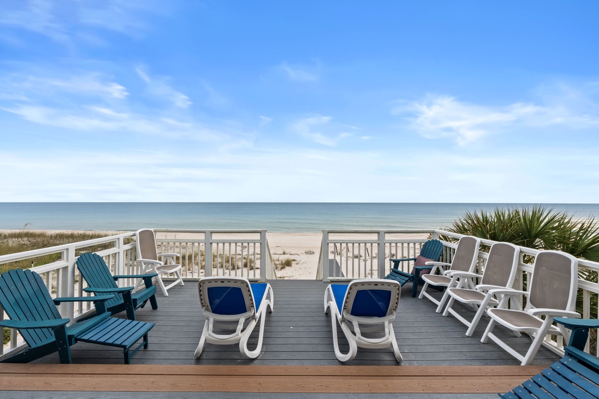 Step onto your private beachfront deck where comfortable lounge chairs await and ocean breezes meet endless blue horizons.