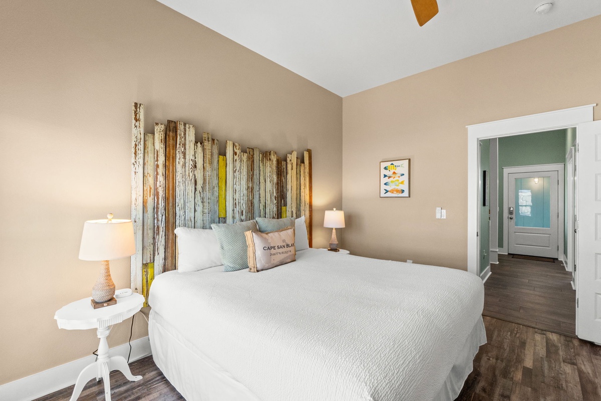 Drift into peaceful sleep in your coastal-inspired bedroom, where rustic wood headboard and soft linens create the perfect retreat.