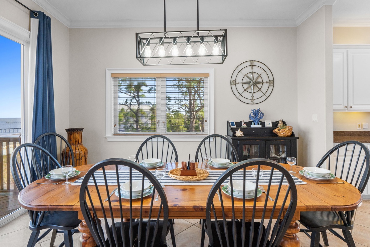 Gather around your spacious dining table for memorable meals, with coastal charm and warm lighting creating the perfect atmosphere.